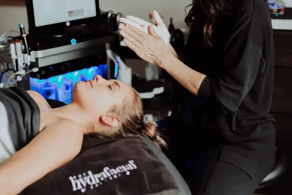 Patient relaxing on spa bed for Hydrafacial treatment | Wellness Co. | Zeeland, MI